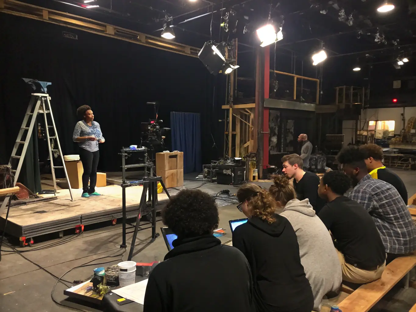 A dynamic image of students participating in a technical theatre workshop at MINI THEATRE DE MARSEILLE, focusing on lighting, sound, and stage management.